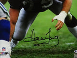 Howie Long Autographed Oakland Raiders 16x20 PF In Stance- Beckett Auth *Black