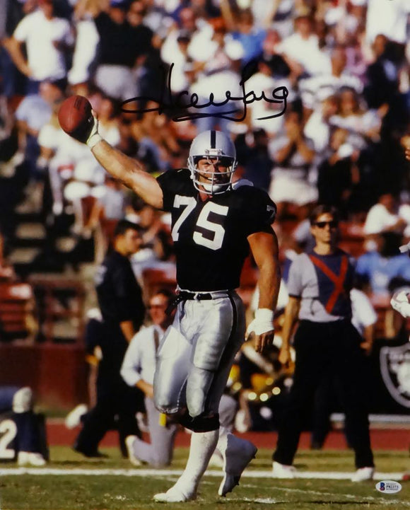 Howie Long Autographed Oakland Raiders 16x20 Holding Ball Up- Beckett Auth *Black